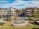 Aerial view of a charming street with shops, apartments, and a park with a fountain on a sunny day at 531 Burton Dr, Alpharetta, GA 30009
