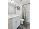 Clean bathroom with modern vanity, white cabinets, and a shower-tub combination at 531 Burton Dr, Alpharetta, GA 30009