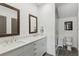 Modern bathroom featuring double sinks, sleek white cabinetry, and glass-enclosed shower at 531 Burton Dr, Alpharetta, GA 30009