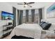 Bright bedroom with stylish decor, ceiling fan, comfortable bed, and modern media center at 531 Burton Dr, Alpharetta, GA 30009