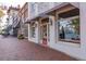 Exterior shot of a commercial building with retail space, featuring large windows, awning, and brick sidewalk at 531 Burton Dr, Alpharetta, GA 30009
