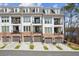 Modern townhome exterior featuring attached garages, brick accents, and private balconies at 531 Burton Dr, Alpharetta, GA 30009