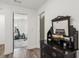 Charming hallway featuring a vintage dresser and views into a bright workout room at 531 Burton Dr, Alpharetta, GA 30009