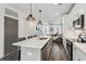 Bright kitchen with white cabinets, a large island, and a view into the living room at 531 Burton Dr, Alpharetta, GA 30009