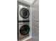 Modern LG brand stackable washer and dryer in silver finish nestled in a closet at 531 Burton Dr, Alpharetta, GA 30009
