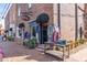 Storefront featuring clothing and accessories, with brick exterior and a display of merchandise on tables at 531 Burton Dr, Alpharetta, GA 30009
