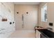 Modern bathroom with marble wall, dual shower heads, and freestanding black soaking tub at 245 Roycroft Ln, Fayetteville, GA 30214