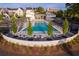 Aerial view of a luxurious community pool lined with lounge chairs, perfect for relaxation and socializing at 245 Roycroft Ln, Fayetteville, GA 30214