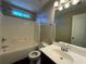 Bathroom with a vanity and sink, toilet and a tub with shower and bright lighting at 287 Bramlett Meadows Dr, Douglasville, GA 30134