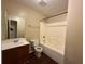 Bathroom with a vanity and sink, toilet and a tub with shower and bright lighting at 287 Bramlett Meadows Dr, Douglasville, GA 30134