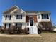 Two-story home featuring brick accents and a white staircase leading to the front door entrance at 287 Bramlett Meadows Dr, Douglasville, GA 30134
