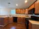 Functional kitchen featuring wood cabinets, black appliances, and modern countertops at 287 Bramlett Meadows Dr, Douglasville, GA 30134