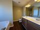Main bathroom featuring double sinks, soaking tub, and a separate shower at 287 Bramlett Meadows Dr, Douglasville, GA 30134