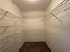 Walk-in closet with white shelving and ample storage space at 287 Bramlett Meadows Dr, Douglasville, GA 30134