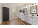 Stylish bathroom featuring a double vanity, framed mirrors, modern lighting, and a glass-enclosed shower at 937 Willingham Dr # 7, Hapeville, GA 30354