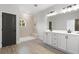 Modern bathroom with double vanity, white cabinets, and a walk-in shower with decorative tiles at 937 Willingham Dr # 7, Hapeville, GA 30354