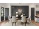 Elegant dining room with dark accent wall, chandelier, modern table and chairs at 937 Willingham Dr # 7, Hapeville, GA 30354