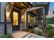Inviting front porch with stone accents, stylish lighting, and a cozy seating area visible through the front door at 937 Willingham Dr # 7, Hapeville, GA 30354