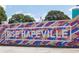 Vibrant mural that reads 'Rise Hapeville' on the side of a commercial building at 937 Willingham Dr # 7, Hapeville, GA 30354