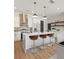 Bright kitchen features an island with barstool seating, stainless steel appliances, and modern pendant lighting at 937 Willingham Dr # 7, Hapeville, GA 30354