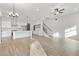 Open-concept living space with hardwood floors, stairs, kitchen view and modern lighting at 937 Willingham Dr # 7, Hapeville, GA 30354