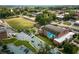 Aerial view of a school campus including the football field, muralled gymnasium, and surrounding foliage at 941 Willingham Dr # 5, Hapeville, GA 30354