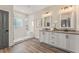 Bright bathroom featuring a double vanity, framed mirrors and walk-in shower with a tiled accent wall at 941 Willingham Dr # 5, Hapeville, GA 30354