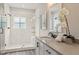 Bathroom showcasing a modern single vanity with walk-in shower that features bright, herringbone patterned tiles at 941 Willingham Dr # 5, Hapeville, GA 30354