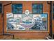 Brick wall with a mural that celebrates Hapeville's history with images of trains and automobiles at 941 Willingham Dr # 5, Hapeville, GA 30354