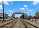 View of pedestrian bridge crossing train tracks, set in a commercial area on a clear day with few clouds at 941 Willingham Dr # 5, Hapeville, GA 30354