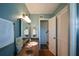 This blue bathroom features a wood vanity, walk-in shower, and views to the stairway at 2112 Starfire Ne Dr, Atlanta, GA 30345