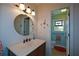 Cozy bathroom featuring a pedestal sink and a doorway view of a toilet with a stained-glass window at 2112 Starfire Ne Dr, Atlanta, GA 30345