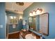 Bathroom with walk-in shower, wood-trimmed mirror and vanity with sink, and window overlooking wooded area at 2112 Starfire Ne Dr, Atlanta, GA 30345