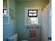 Charming bathroom featuring a decorative stained-glass window above the toilet and mermaid-themed artwork at 2112 Starfire Ne Dr, Atlanta, GA 30345