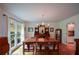 Light-filled dining room features hardwood floors, a chandelier, and view of backyard at 2112 Starfire Ne Dr, Atlanta, GA 30345