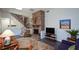 Cozy living room featuring a brick fireplace, comfortable seating, and staircase leading to upper level at 2112 Starfire Ne Dr, Atlanta, GA 30345