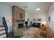 Spacious living room featuring a brick fireplace, comfortable seating, and a staircase with dark railings at 2112 Starfire Ne Dr, Atlanta, GA 30345