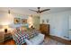 Bright and cozy bedroom featuring hardwood floors, a unique ceiling fan, and stylish decor at 2112 Starfire Ne Dr, Atlanta, GA 30345