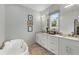 This luxurious bathroom features a soaking tub, double vanity, and neutral tones to create a relaxing space at 219 Howell Se Dr # A, Atlanta, GA 30316