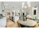 Open-concept kitchen with island, stainless steel appliances, stylish lighting, and adjacent dining area at 219 Howell Se Dr # A, Atlanta, GA 30316