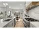 Open concept kitchen with stainless appliances, a large island, and stylish lighting fixtures at 219 Howell Se Dr # A, Atlanta, GA 30316