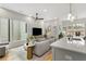 Bright living room and kitchen area with hardwood floors, large windows, and stylish modern decor at 219 Howell Se Dr # A, Atlanta, GA 30316