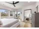 Bright main bedroom boasts hardwood floors, modern ceiling fan, and large windows allowing natural light to illuminate the space at 219 Howell Se Dr # A, Atlanta, GA 30316