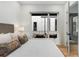 The main bedroom includes designer textiles, a neutral palette, and access to a private balcony at 219 Howell Se Dr # A, Atlanta, GA 30316