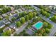 Aerial view showcases a neighborhood swimming pool surrounded by lush trees and well-maintained homes at 310 Tuggle Court, Woodstock, GA 30188