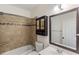 Cozy bathroom featuring tiled walls, a vanity with a framed mirror, and a shower/tub combo at 310 Tuggle Court, Woodstock, GA 30188
