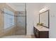 Stylish bathroom with a walk-in shower featuring glass enclosure, tiled surround and modern vanity at 310 Tuggle Court, Woodstock, GA 30188