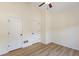 Spacious bedroom with two closets, ceiling fan, and light wood flooring at 310 Tuggle Court, Woodstock, GA 30188