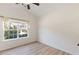 Bright bedroom featuring a large window with lush green views and light wood flooring at 310 Tuggle Court, Woodstock, GA 30188
