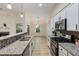 Well-equipped kitchen with stainless steel appliances, granite countertops, and modern white cabinets at 310 Tuggle Court, Woodstock, GA 30188